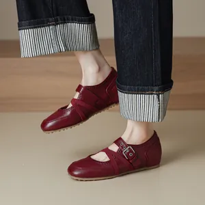 Elegant red retro leather Mary Jane ballet flats with cross straps shown on model