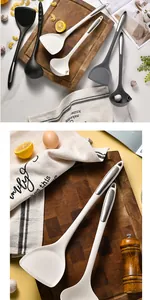 Close-up of white silicone spatula and soup ladle on wooden cutting board
