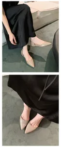 Detailed macro view of French nude pointed-toe flat shoes with hollow-out side design