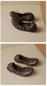 Close-up of brown French-style ballet flats with bow and elastic detail