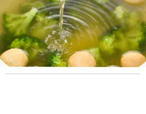 Close-up of healthy soup with broccoli and meatballs for oil separation spoon detail