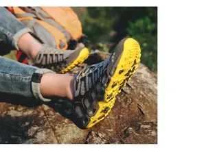 Close-up detail of breathable mesh hiking shoes with durable yellow rubber traction soles