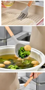 Macro details of silicone basting brush and slotted spoon with wooden handles in use.