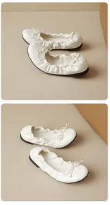 Macro detail view of cream ballet flats with soft leather texture and bow tie detail