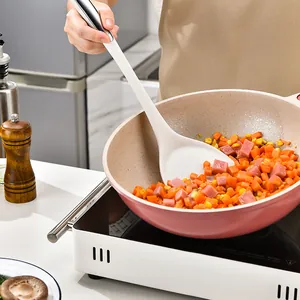 Premium white silicone soup ladle shown in use within a pink pan with diced vegetables