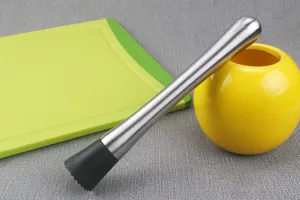 Close-up of a 304 stainless steel cocktail muddler with a black nylon head on a grey surface