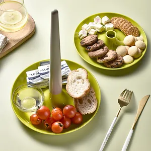 Two-tier green plastic serving tray for desserts and snacks with detachable center post
