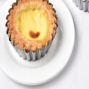Close-up detail of a 430 stainless steel reusable egg tart mold with a fresh baked tart