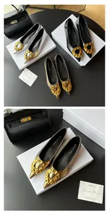 Detailed view of pointed-toe flat shoes featuring an elegant golden metal buckle