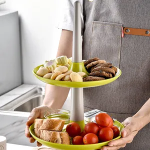 Two-tier green plastic fruit and dessert stand with detachable trays for afternoon tea