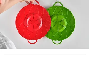 Detail view of red and green flower-shaped silicone spill-proof pot lids with water drops