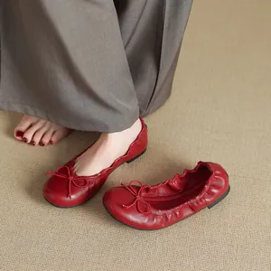 Elegant French style red ballet flats featuring a dainty bow and soft flexible sole