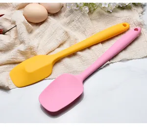 Detailed view of two 28cm food-grade silicone baking spatulas in pink and yellow.