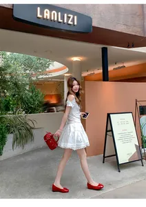 Stylish side view of a woman walking in red French style ballet flats with bow detail