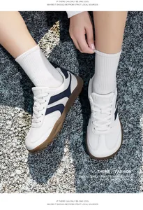 Detailed view of breathable mesh sneakers with classic navy stripes on a gravel surface