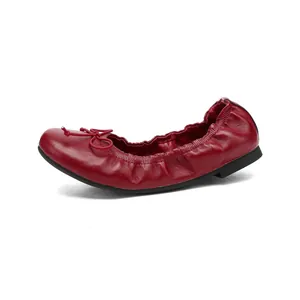Elegant red leather ballet flats featuring a delicate bow and elastic rim for comfort