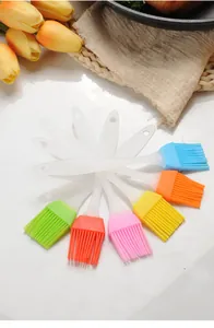 Close-up of colorful silicone basting brushes with translucent handles in a fan layout