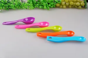 Detailed macro view of five colorful plastic measuring spoons in various vibrant sizes.