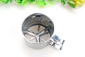Detailed top view of the internal rotating blades and mesh of a stainless steel flour sifter