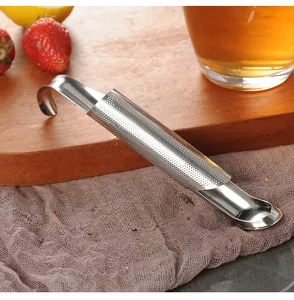 Detailed view of a 304 stainless steel pipe tea infuser placed on a rustic wooden board