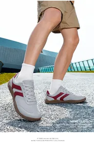 Breathable flyknit mesh GAT sneakers in grey with maroon stripes shown outdoors