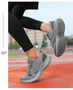 Grey breathable mesh running shoes for men shown in an outdoor sports setting