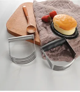 Close-up of stainless steel pastry blenders with metal and black rubber handles for baking