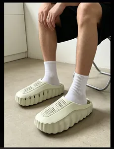 Detailed view of cream-colored thick sole clogs worn with socks in a home setting