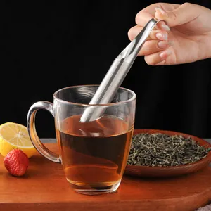 304 stainless steel pipe tea infuser strainer being dipped into a clear glass mug of tea