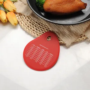 Red teardrop silicone scraper with measurement conversion table for baking and cooking.