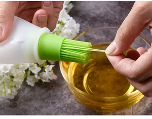 Close-up view of flexible green silicone bristles on a kitchen oil bottle brush for cooking