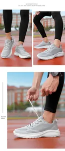 Detail view of grey breathable mesh running shoes for men on a red sports track.