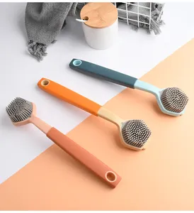 Detail view of colorful silicone kitchen brushes with ergonomic long handles.