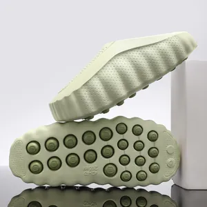 Thick-soled pale green garden clogs showing side profile and anti-slip sole texture