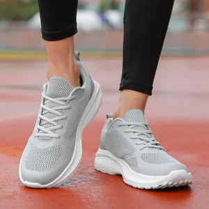 Grey mesh breathable men's sports shoes with white cushioned soles for running.
