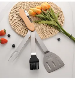 Detailed view of the unfolded multi-functional BBQ tool set with wooden handle