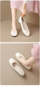 Detail view of cream ballet flats with soft sole, round toe, and elegant bow decoration.