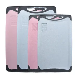 Set of 4 wheat straw cutting boards with built-in grinders and non-slip edges.