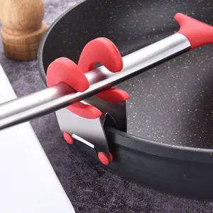 Stainless steel pot side clip and kitchen utensil holder attached to a frying pan rim
