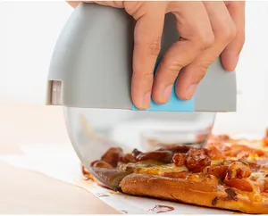 Detailansicht: Edelstahl-Pizzaschneider schneidet eine frisch gebackene Pizza
