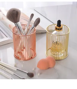 Detailansicht der goldenen und roségoldenen Draht-Organizer für Make-up-Pinsel.
