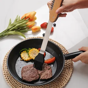 Multi-functional stainless steel BBQ tool with wooden handle, featuring a silicone oil brush