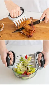 Detailed view of stainless steel bear claw meat shredders shredding meat and salad