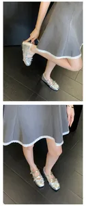 Close-up of silver Mary Jane ballet flats with bow detail and hidden wedge on a model