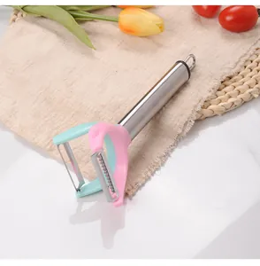 Stainless steel dual-head peeler and shredder for household vegetable preparation.