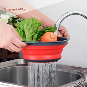 Red and grey collapsible silicone colander for washing vegetables and fruits in sink
