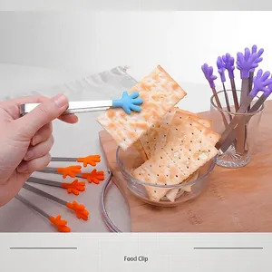 Versatile small silicone food tongs with hand-shaped tips for snacks, crackers, and ice.
