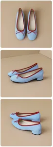 Detailed view of elegant light blue suede ballet flats featuring red trim and a cute bow.