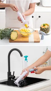 Detail view showing pineapple corer being used to slice fruit and washed under a faucet