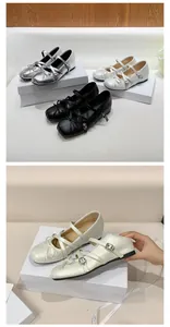 Detail view of French style Mary Jane flats with bow and cross straps on white box.